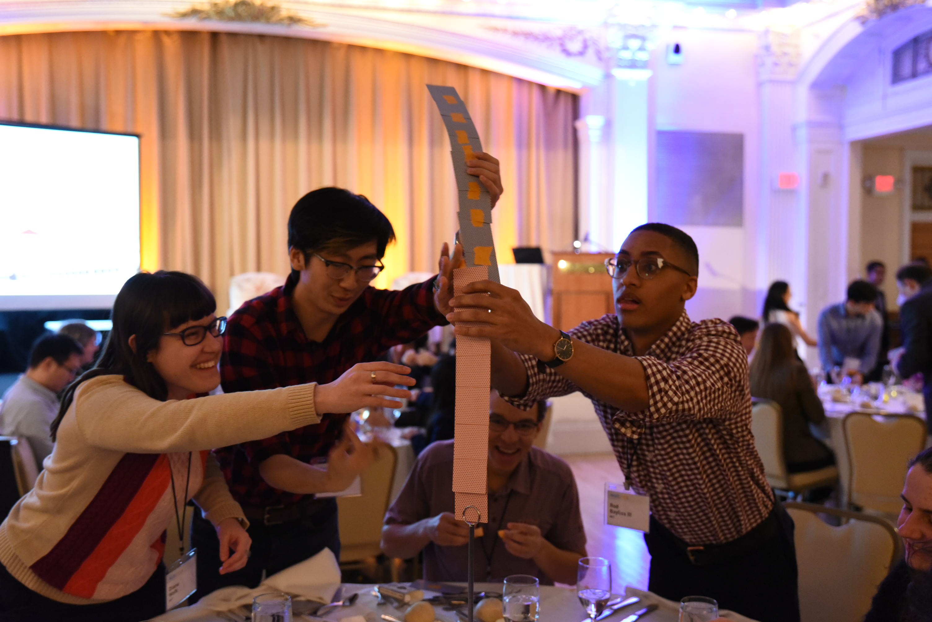 MARC attendees build a tower with playing cards.